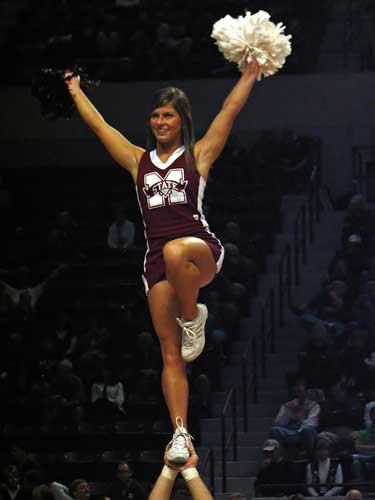 Bulldog cheerleader flips high in the air