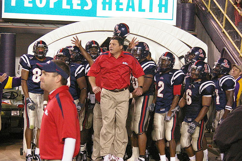  Ed Orgeron leads the Rebels onto the field.