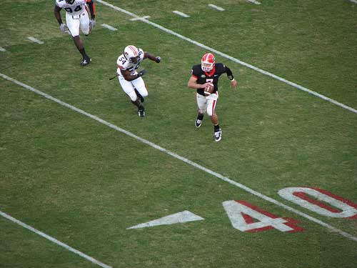  Georgia quarterback Matthew Stafford runs away from Auburn defender 