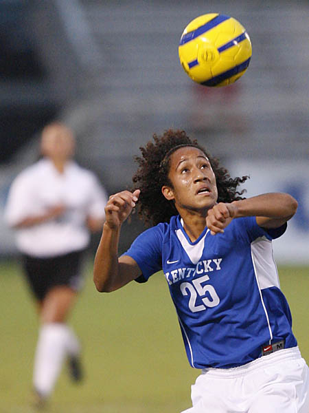 Lady Wildcat heads soccer ball