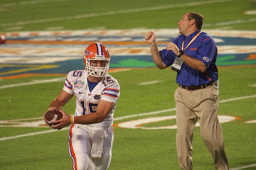  Tim Tebow on field with Dan Mullen.